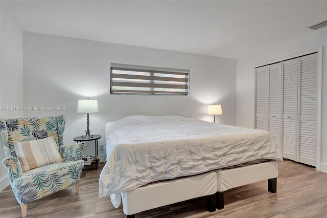 bedroom with hardwood / wood-style flooring and a closet