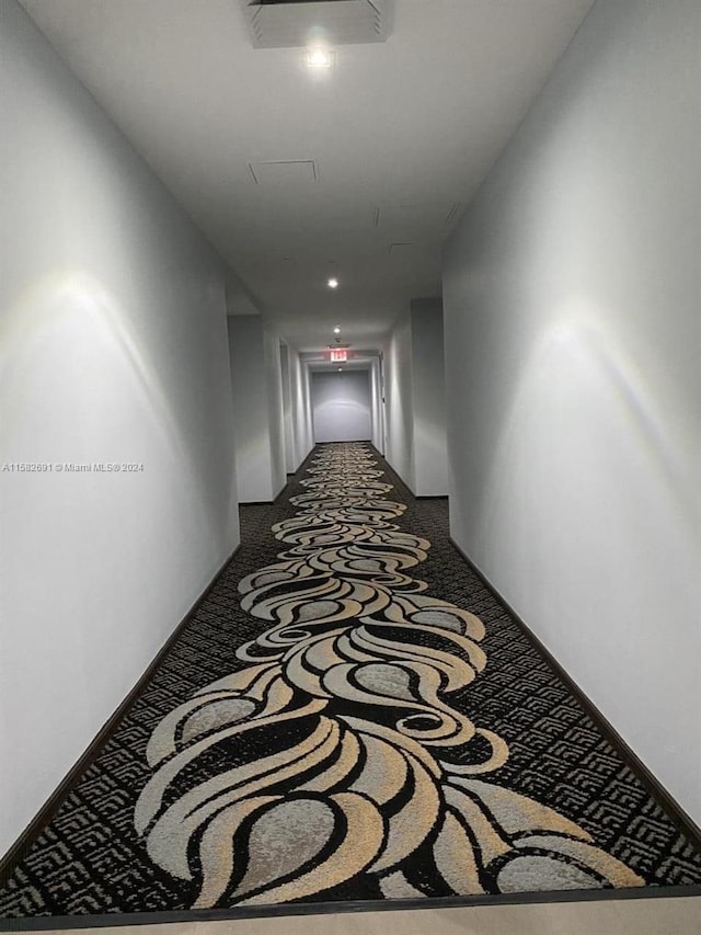 hall featuring carpet flooring