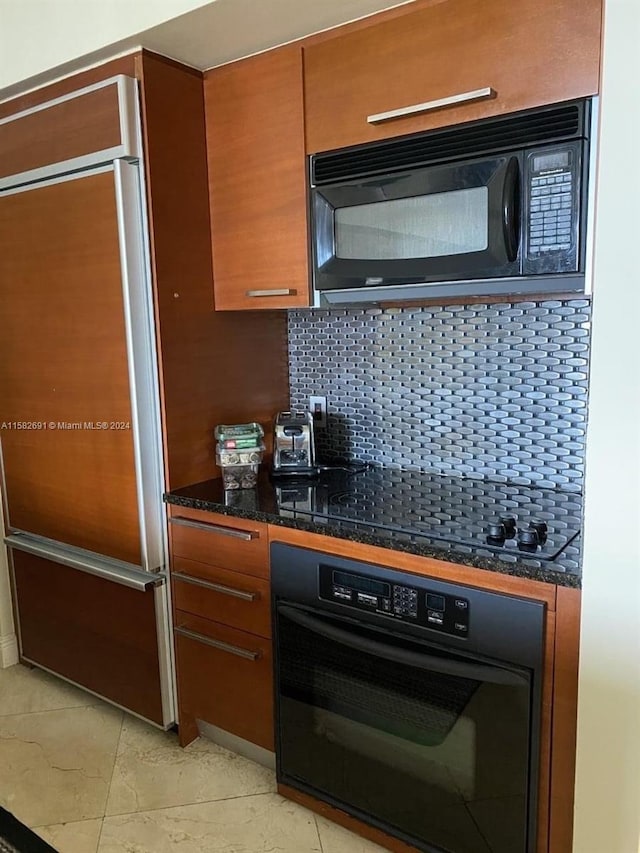 kitchen featuring black appliances, tasteful backsplash, and light tile flooring