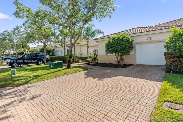 view of front of property featuring a garage and a front lawn