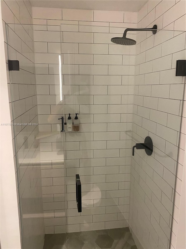 bathroom with tiled shower