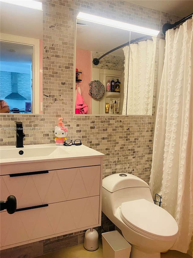 bathroom featuring toilet, tasteful backsplash, and vanity