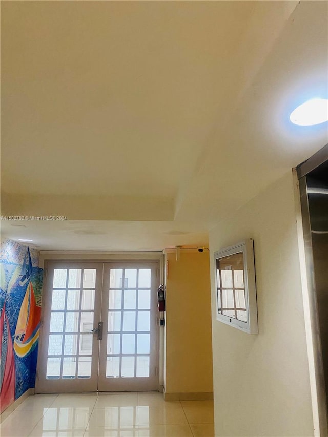 doorway with light tile patterned floors and french doors