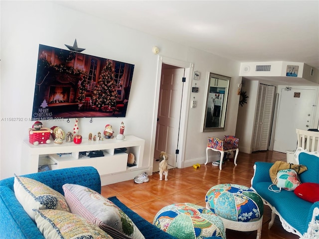 living room with tile patterned floors and a high end fireplace