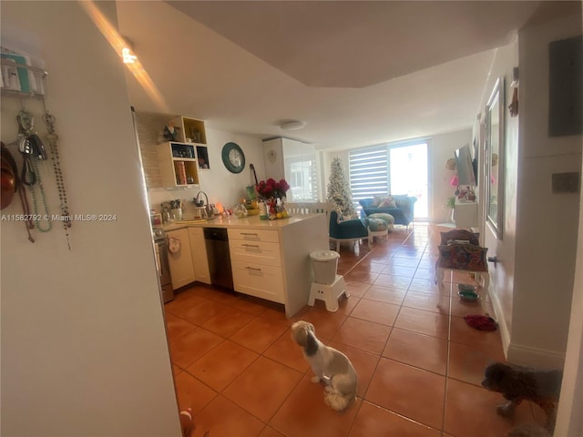 kitchen with white cabinets, light tile patterned flooring, and stainless steel appliances