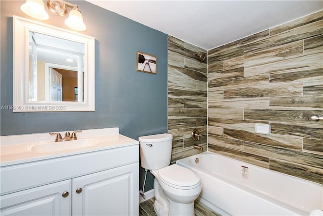 full bathroom featuring vanity, tiled shower / bath combo, and toilet