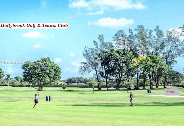 view of property's community with a lawn