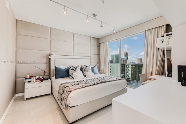 bedroom featuring access to outside and track lighting