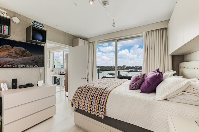 bedroom featuring access to exterior and light tile patterned floors