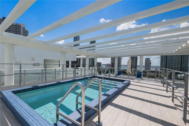 view of swimming pool with a pergola and a patio