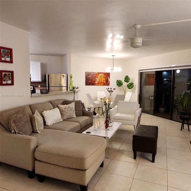 living room featuring a chandelier and light tile floors