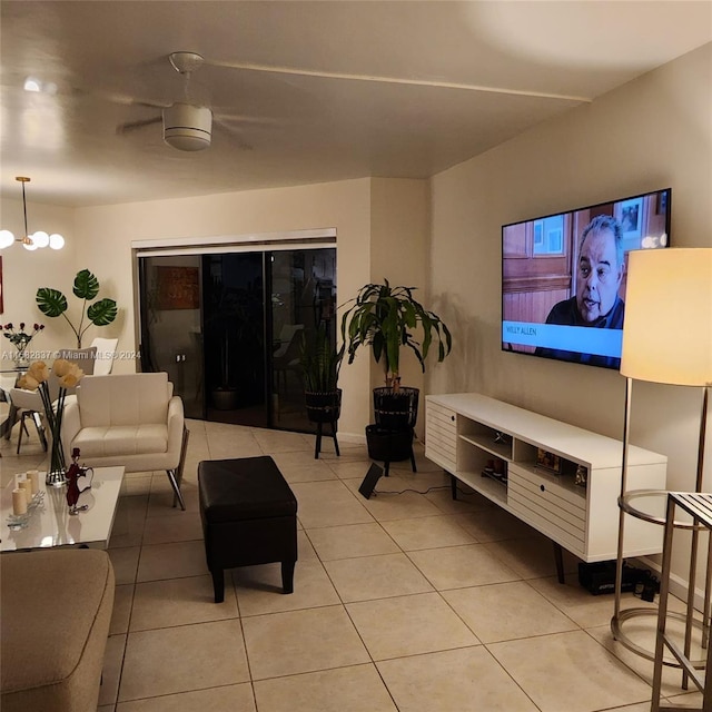 tiled living room featuring a chandelier