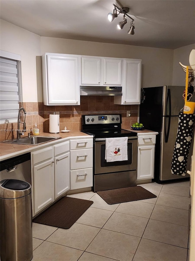 kitchen featuring white cabinets, sink, tasteful backsplash, and stainless steel appliances