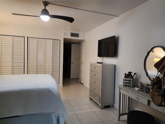 tiled bedroom featuring ceiling fan