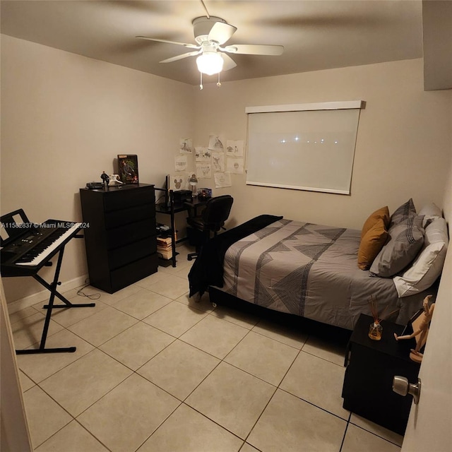 tiled bedroom featuring ceiling fan