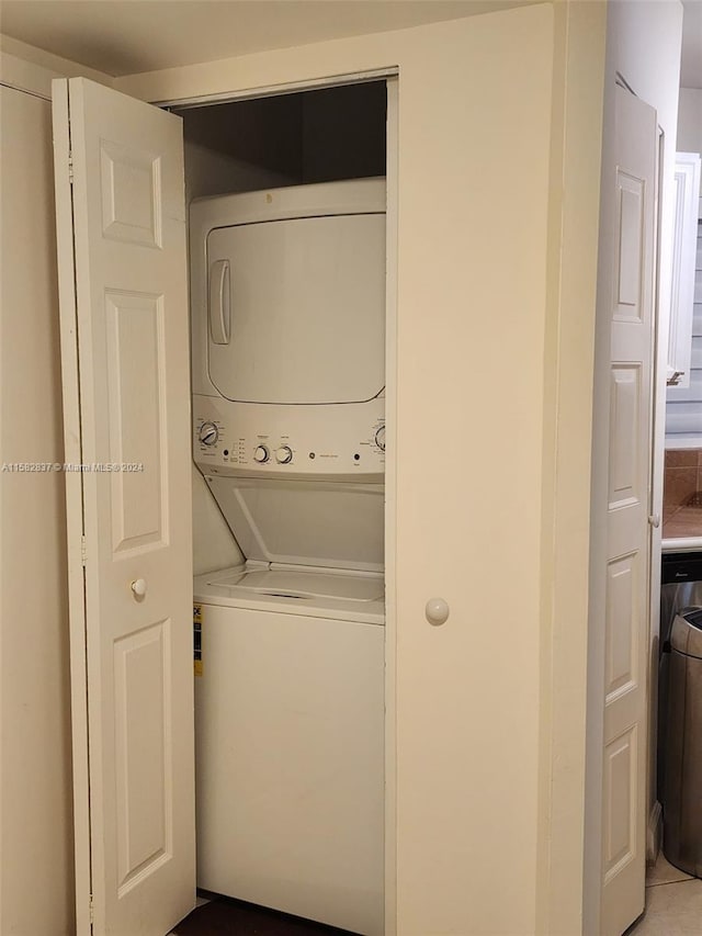 clothes washing area featuring stacked washer and dryer