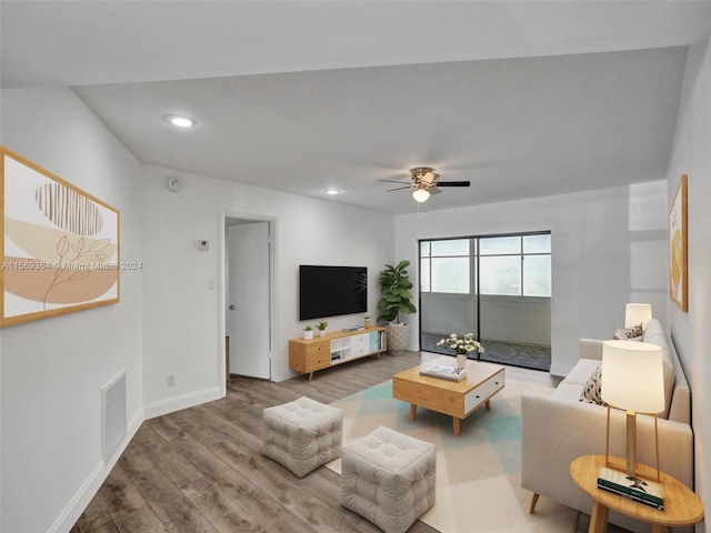 living room featuring hardwood / wood-style floors and ceiling fan