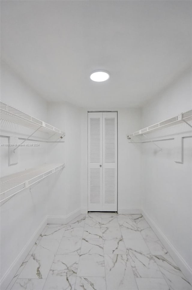 spacious closet featuring light tile patterned floors