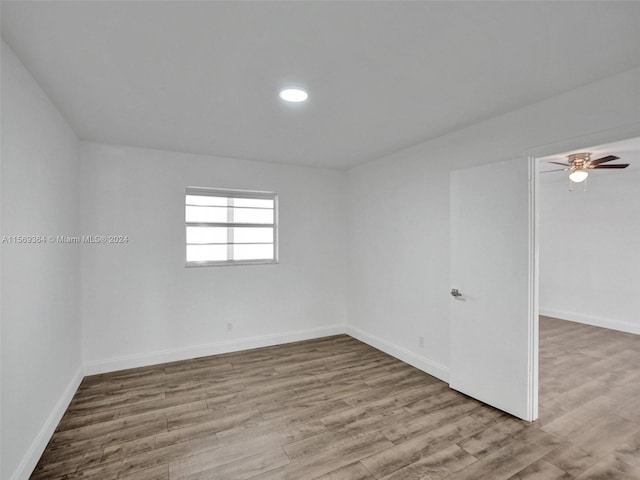 spare room with ceiling fan and wood-type flooring