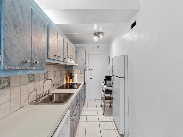 kitchen with black electric stovetop, light tile flooring, backsplash, white fridge, and sink