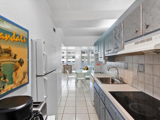 kitchen with light tile floors, tasteful backsplash, white appliances, and sink