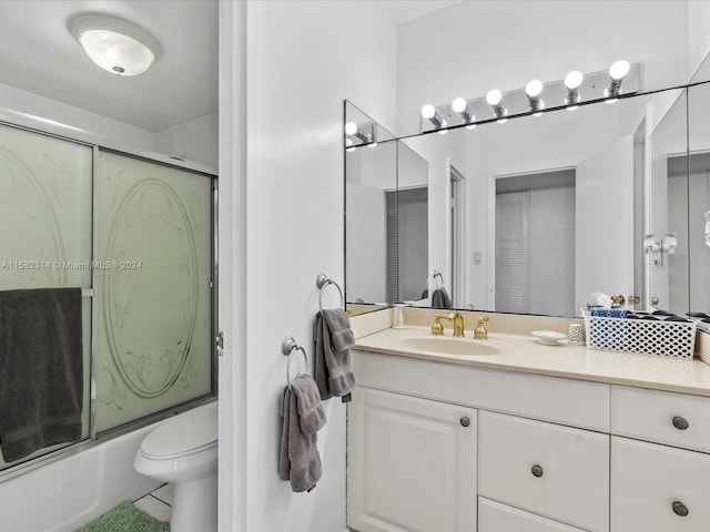 full bathroom with shower / bath combination with glass door, vanity, toilet, and tile flooring