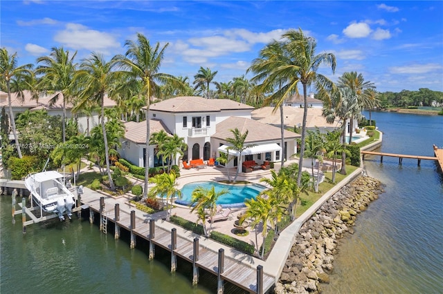 back of property featuring a patio and a water view