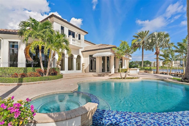 view of swimming pool with a patio and an in ground hot tub