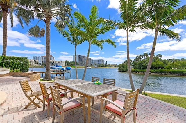 view of terrace with a water view and a dock