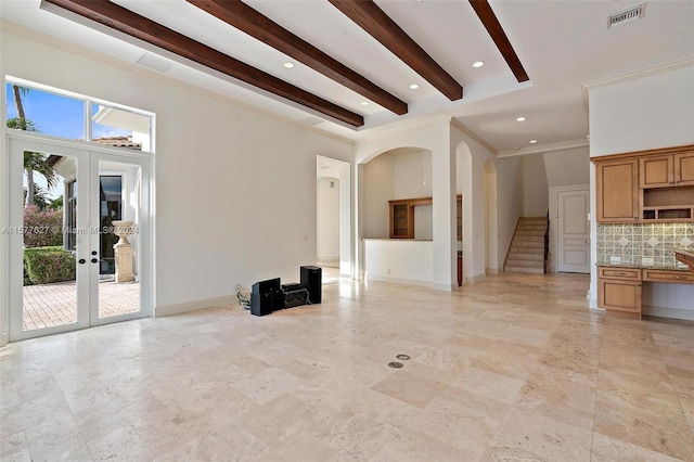 unfurnished living room with french doors, ornamental molding, beamed ceiling, and light tile floors