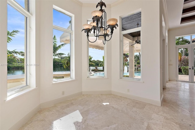 unfurnished dining area with a wealth of natural light, tile floors, and a chandelier