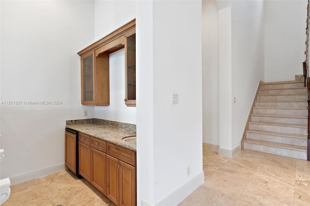 kitchen with light tile floors and light stone counters