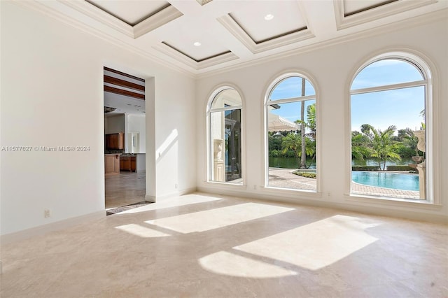 spare room with beamed ceiling, plenty of natural light, coffered ceiling, and tile flooring