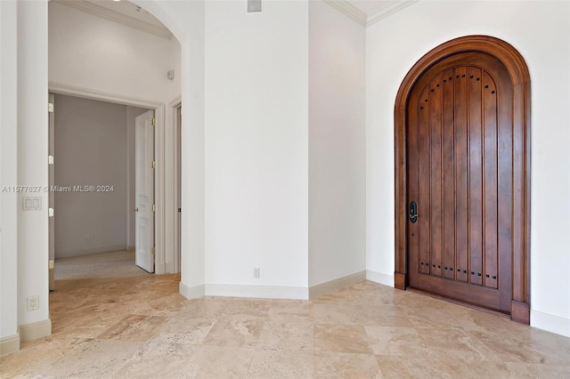 entrance foyer with ornamental molding and light tile floors