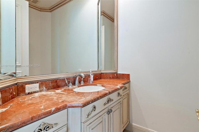 bathroom with vanity and ornamental molding