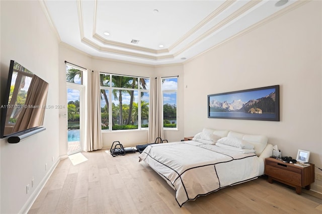 bedroom featuring wood-type flooring, a raised ceiling, access to outside, and ornamental molding