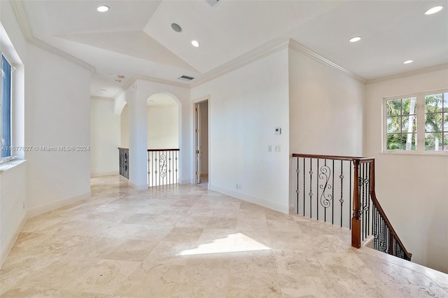 corridor with tile flooring, vaulted ceiling, and ornamental molding