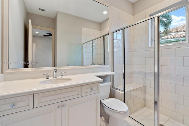 bathroom featuring walk in shower, toilet, and large vanity