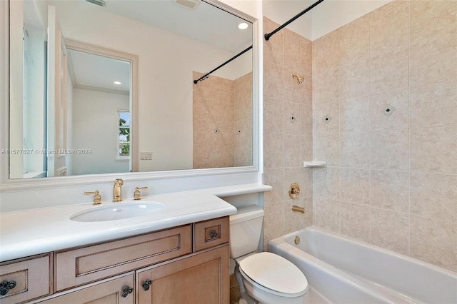 full bathroom with tiled shower / bath combo, vanity, and toilet