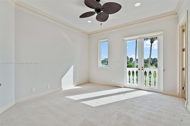 carpeted spare room featuring french doors, crown molding, and ceiling fan