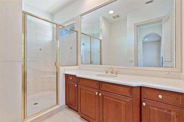 bathroom featuring walk in shower, tile floors, and vanity