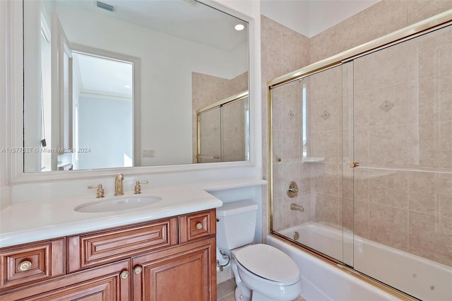 full bathroom with toilet, bath / shower combo with glass door, and large vanity