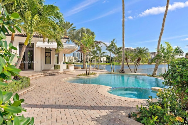 view of pool with a patio and an in ground hot tub