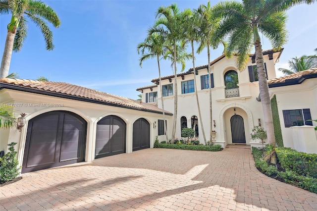 mediterranean / spanish house with a garage