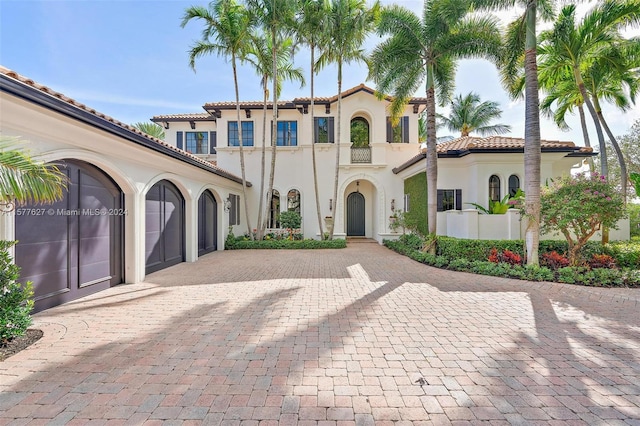 mediterranean / spanish home featuring a garage