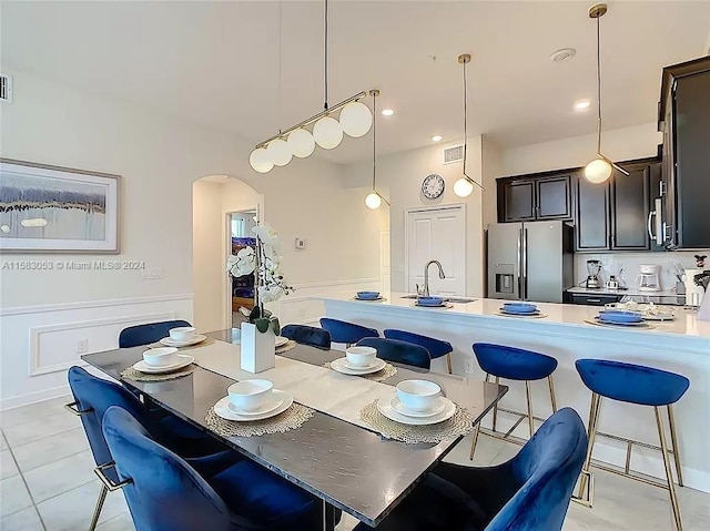 tiled dining space featuring sink