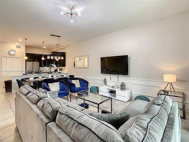 tiled living room with an inviting chandelier