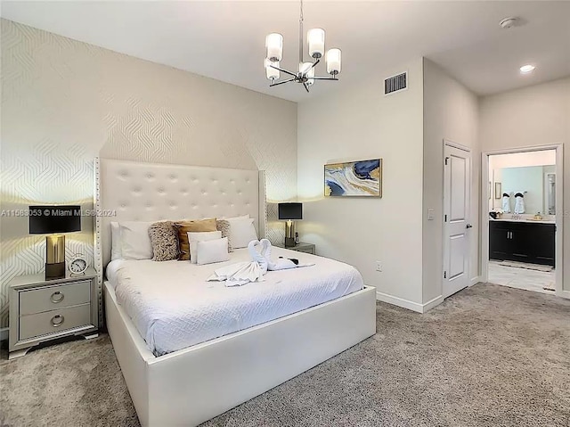 carpeted bedroom featuring an inviting chandelier and connected bathroom