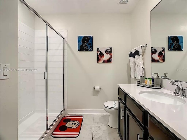 bathroom featuring tile flooring, vanity, an enclosed shower, and toilet