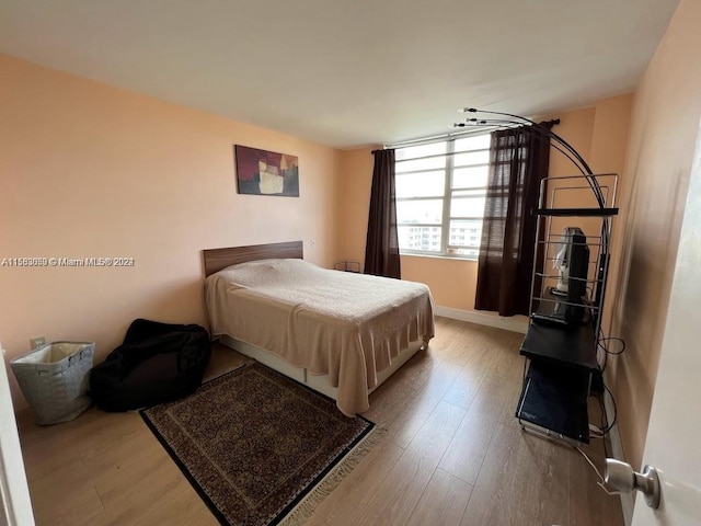 bedroom with hardwood / wood-style floors